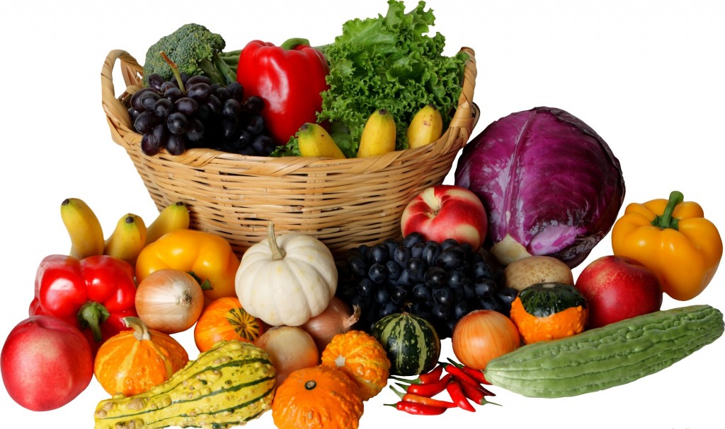 picture of vegetables in a basket with vegetables surrounding the basket.