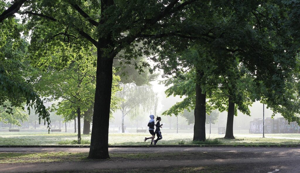 Two people running in a park