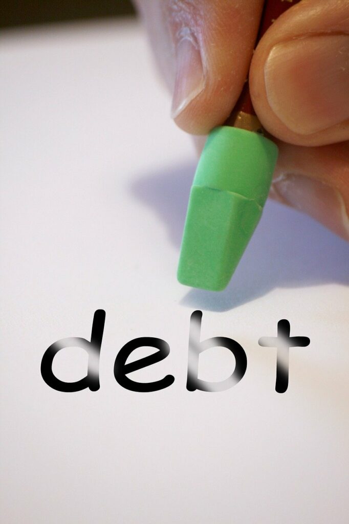 the word debt with an eraser above it. 