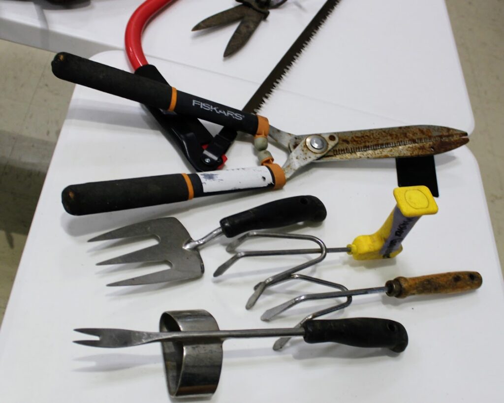Pruning and digging tools on a table.